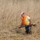 Photo représentant l'activité d'entretien des espaces verts d'OASURE. On observe un salarié en train de faucarder (couper les roseaux) avec une débroussailleuse.